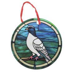 a stained glass ornament with a bird on it