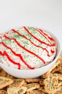 a bowl filled with white frosted christmas crackers and sprinkles on top