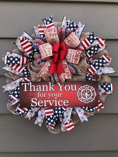 a fire department wreath with the words thank you for your service written in red, white and blue