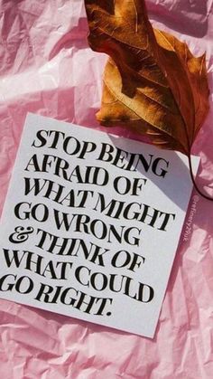 a leaf laying on top of a piece of paper with the words stop being afraid of what might go wrong