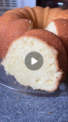 a bundt cake is cut in half and sitting on a glass plate with the video below it