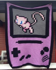 a pink and black knitted blanket with an image of a cat on the screen