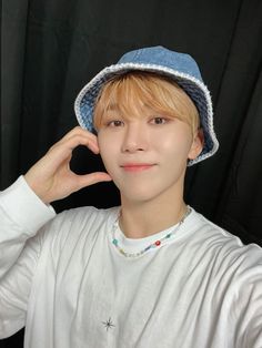 a young man wearing a blue hat and white shirt