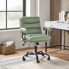 a green office chair sitting on top of a rug in front of a white desk