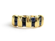 a gold ring with blue stones on it