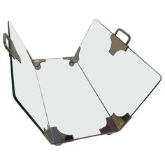 a mirror that is sitting on top of a table with handles and two pieces of glass in it