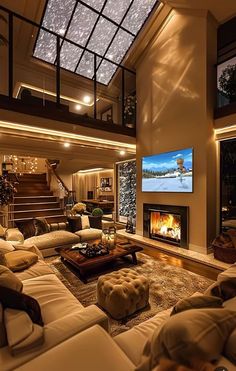 a living room filled with lots of furniture and a flat screen tv mounted to the wall