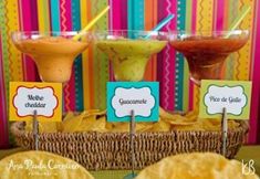 some tacos and guacamole are sitting on a table with place cards