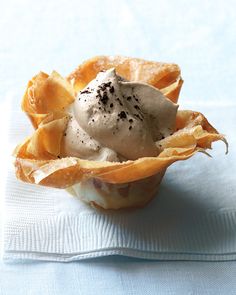 a bowl filled with food sitting on top of a white napkin