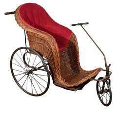 an old fashioned wicker buggy with a red seat