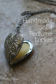 a heart shaped locke on a chain with the words handmade solid perfume locke written below it