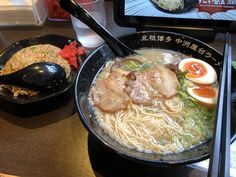 a bowl of ramen with chopsticks on the side