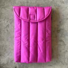 a pink sleeping bag laying on the ground