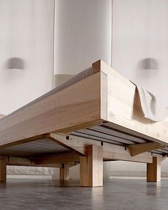 a bed that is sitting on top of a wooden platform in the middle of a room