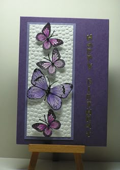 a purple card with three butterflies on it