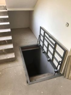 an empty room with stairs and a hole in the floor