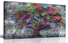 a colorful tree on a gray background with lots of paint splattered all over it