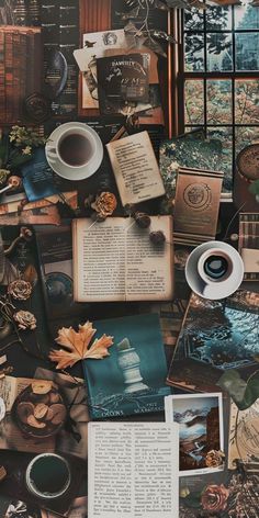 an assortment of books, magazines and other items spread out in front of a window