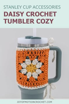 an orange and white crochet mug cozy with the words stanley cup accessories daisy crochet tumbler cozy