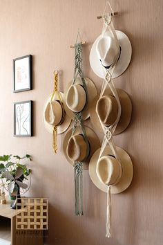 hats are hanging on the wall with tassels attached to it and other accessories