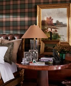 a bedroom with plaid wallpaper and leather furniture