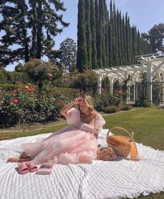 a woman sitting on top of a white blanket