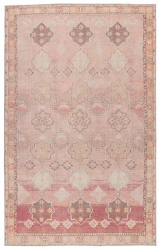 an antique rug with red and beige colors