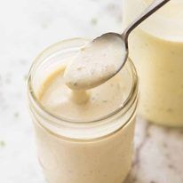 a spoon in a jar with some liquid