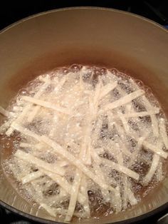 the food is being cooked in the pot on the stove