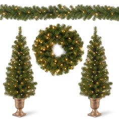 three christmas trees with lights on them and a wreath hanging from the top, in gold vases