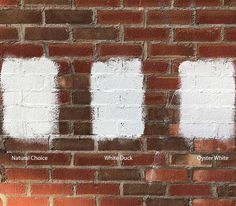 the words white painted on a brick wall