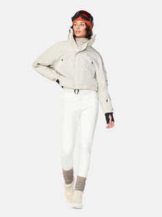 Inspired by vintage ski suits, modernized with sustainable materials. The 80's style bat-wing upper has a classic blouson silhouette matched with fitted, fleece-lined stirrup pants to round out the iconic look. The jacket is made with GRS certified fabric and insulated with 100% recycled Primaloft-Eco®. The pants repel snow and water thanks to the Schoeller fabric's Bio-Based finish that mimics the way plants naturally shed water without resorting to environmentally harmful chemicals. The top an Snow Suits For Women, Ski Jumpsuit, Stirrup Pants, Snow Outfit, Ski Suit, Bat Wing, Vintage Silhouette, Skiing Outfit, Vintage Ski