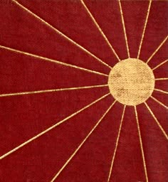 an old red and gold cloth with white lines on the center, as well as a circle in the middle