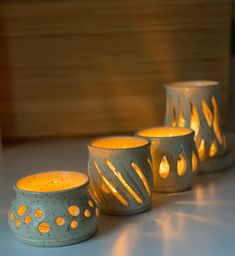 three lit candles sitting next to each other on a table