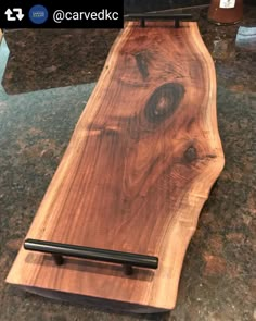 a wooden cutting board sitting on top of a counter next to a knife rester