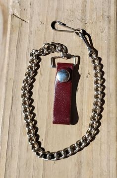 Very nice Mens wallet chain for his belt. Keeps wallet or keys safe. Not lost.  Measures over all about 18" inches and the chain part only measures 12" inches.   The belt opening is 2" inches.  The leather looks brown, but in the sunlight it also looks burgundy.  Hard to say for sure!  lol   Comes with two hooks.  See my photos. Ask any questions before you buy.  Thank you for visiting my shop! ~Peggy Key Safe, Mens Wallet, Clip Wallet, Chain Belt, Money Clip Wallet, Belt Clip, Wallet Chain, Money Clip, Wallet Men