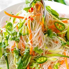 a white plate topped with veggies and noodles