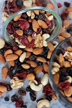 two glass jars filled with nuts and raisins