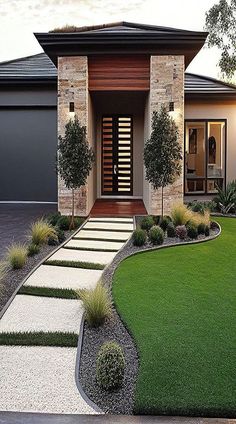 a modern house with landscaping in the front yard and driveway leading up to it's entrance