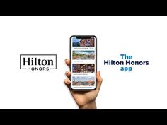 a person holding an iphone in their hand with the hilton motors app on it's screen