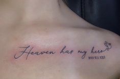 a woman's chest with the words heaven has my heart tattooed on her left shoulder