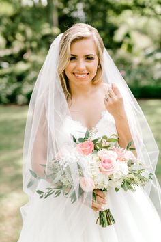 a woman in a wedding dress holding a bouquet