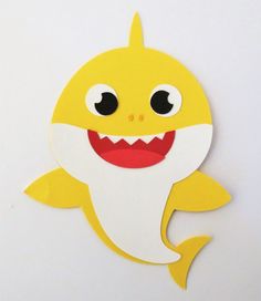 a paper cut out of a smiling yellow shark