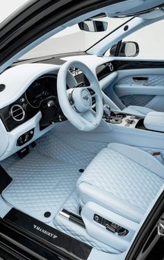 the interior of a car with all white leather