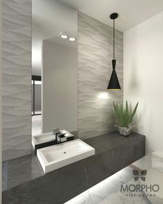 a bathroom with a sink, mirror and plant in it