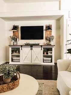 a living room filled with furniture and a flat screen tv mounted to the side of a wall