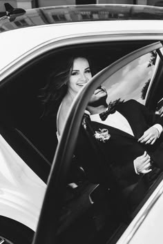 a woman sitting in the driver seat of a car