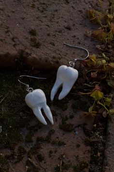 Gleaming white in the moon's soft glow, the teeth of the night whisper secrets below. Indulge in this Halloween season with these adorable teeth earrings! Crafted from high-quality polymer clay and stainless steel hardware, each piece is hand-painted with intricate details. Measuring approximately 1.25 inches, these lightweight earrings are perfect for adding a mystical touch to your everyday wear. Whether you're a diehard halloween-lover or just someone who appreciates unique accessories, these Teeth Earrings, Night Whispers, Earrings Cute, Light Weight Earrings, Halloween Season, Cute Gift, Cute Earrings, Accessories Unique, Clay Earrings