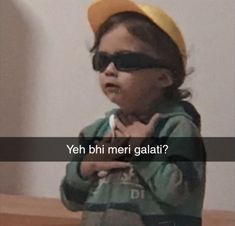 a young child wearing sunglasses and a hat with the words yeh bhi meri galati?