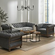 a living room filled with furniture and a chandelier